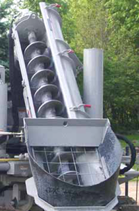 Auger conveyor on the Power Curber 5700-C slipformer